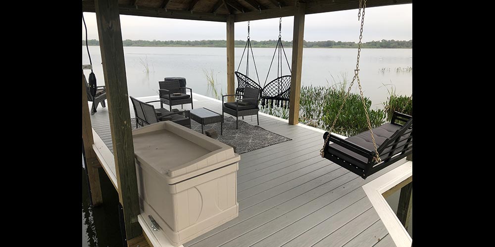 photo of dock with arbor, seating, storage, and swings